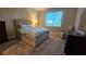 Cozy bedroom with large window, plush carpeting, and a comfortable armchair at 3060 Mountain Spruce Ter, Wesley Chapel, FL 33543