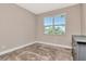 Neutral bedroom with carpeting, a large window, and a dresser, for a calm, peaceful retreat at 3060 Mountain Spruce Ter, Wesley Chapel, FL 33543