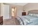 Comfortable bedroom featuring neutral decor, plush carpeting, and an adjacent bathroom at 3060 Mountain Spruce Ter, Wesley Chapel, FL 33543