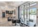 Clubhouse featuring open concept kitchen, island seating, dining tables and expansive windows with an outdoor view at 3060 Mountain Spruce Ter, Wesley Chapel, FL 33543