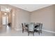 Elegant dining room with round table, six chairs, and neutral paint, seamlessly flowing from entry at 3060 Mountain Spruce Ter, Wesley Chapel, FL 33543