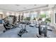 Bright fitness center equipped with treadmills, elliptical machines, stationary bikes, and weight machines at 3060 Mountain Spruce Ter, Wesley Chapel, FL 33543