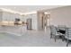 Open-concept kitchen with white cabinets, stainless steel appliances, and views of the dining area at 3060 Mountain Spruce Ter, Wesley Chapel, FL 33543