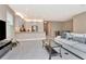 Open living space with tile flooring, contemporary furniture, flowing to kitchen and dining areas at 3060 Mountain Spruce Ter, Wesley Chapel, FL 33543