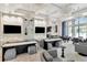 Bright, modern lounge area with stylish seating, chandeliers, and a view into the kitchen at 3060 Mountain Spruce Ter, Wesley Chapel, FL 33543