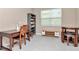 Home office with a wooden desk, chair, bookshelf, and ample natural light streaming through window at 3060 Mountain Spruce Ter, Wesley Chapel, FL 33543