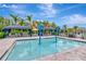A community pool with fun water features for , surrounded by palm trees and lounge seating at 3060 Mountain Spruce Ter, Wesley Chapel, FL 33543