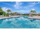 Inviting community pool with crystal clear water and lounge seating surrounded by lush landscaping at 3060 Mountain Spruce Ter, Wesley Chapel, FL 33543