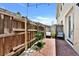 Cozy backyard with brick patio, wooden fence, landscaping, and seating area, perfect for relaxation at 310 S Willow Ave # A, Tampa, FL 33606