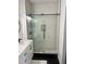 The bathroom features a glass enclosed shower with white subway tile surround, mosaic floor and black trim at 310 S Willow Ave # A, Tampa, FL 33606