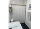 Bathroom featuring black hexagon tile floors, updated vanity with marble countertop, and a shower/tub combo at 310 S Willow Ave # A, Tampa, FL 33606