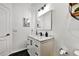 Elegant bathroom features black fixtures, marble countertop, and stylish mirror accents against white walls at 310 S Willow Ave # A, Tampa, FL 33606