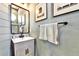 Stylish half bathroom with modern vanity, shiplap accents, and decorative wall art at 310 S Willow Ave # A, Tampa, FL 33606