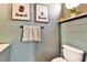 Charming bathroom features cute animal art, a towel rack with soft towels, and a modern toilet at 310 S Willow Ave # A, Tampa, FL 33606