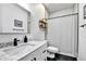 Well-lit bathroom with a modern vanity, marble countertop, sleek fixtures, and a shower with a curtain at 310 S Willow Ave # A, Tampa, FL 33606