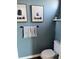 Charming half-bathroom with blue shiplap wall, decorative animal art, and modern fixtures for a touch of whimsy at 310 S Willow Ave # A, Tampa, FL 33606