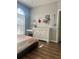 The secondary bedroom includes wood flooring, a large arched window, and a neutral color scheme at 310 S Willow Ave # A, Tampa, FL 33606