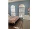 Bedroom featuring natural light with the arched windows and a light-colored paint scheme at 310 S Willow Ave # A, Tampa, FL 33606