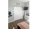 This bedroom features modern decor, wood floors, closet space and a mounted television at 310 S Willow Ave # A, Tampa, FL 33606