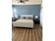 Cozy bedroom featuring a comfy bed with wood-look floors, creating a relaxing and inviting atmosphere at 310 S Willow Ave # A, Tampa, FL 33606