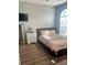 This cozy bedroom features wood floors and a modern dresser with a mirror at 310 S Willow Ave # A, Tampa, FL 33606