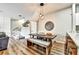 Cozy dining area with modern pendant lighting, a wall clock, and access to the living space at 310 S Willow Ave # A, Tampa, FL 33606