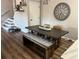 Modern dining room with a wooden table, stylish seating, and staircase at 310 S Willow Ave # A, Tampa, FL 33606