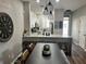 Open-concept dining area with modern lighting fixtures and kitchen view, perfect for entertaining guests and Gathering at 310 S Willow Ave # A, Tampa, FL 33606