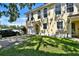 Lovely two-story townhome featuring a one-car garage, lush lawn, and a spacious driveway at 310 S Willow Ave # A, Tampa, FL 33606