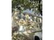 Charming townhome featuring a one-car garage, updated windows, and red tile roofing at 310 S Willow Ave # A, Tampa, FL 33606