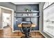 Modern home office with stylish wood desk, floating shelves, and a chair that faces the window at 310 S Willow Ave # A, Tampa, FL 33606