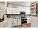 Modern kitchen with white cabinets, stainless steel appliances, and stylish backsplash at 310 S Willow Ave # A, Tampa, FL 33606