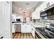 Well-lit kitchen featuring stainless steel appliances, white cabinets, and an open layout at 310 S Willow Ave # A, Tampa, FL 33606