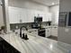Beautiful kitchen with marble countertops, stainless steel appliances, modern faucet and white cabinetry at 310 S Willow Ave # A, Tampa, FL 33606