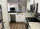 Bright kitchen with marble countertops, stainless steel appliances, and white cabinetry, creating a clean and stylish space at 310 S Willow Ave # A, Tampa, FL 33606