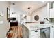 Open-concept kitchen with marble counters, a dining area, and modern pendant lighting at 310 S Willow Ave # A, Tampa, FL 33606