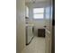 Laundry room featuring white hexagon tiles, washer, dryer, and window at 310 S Willow Ave # A, Tampa, FL 33606