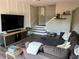 Comfortable living room featuring a large sectional sofa and stairs to the upper level at 310 S Willow Ave # A, Tampa, FL 33606
