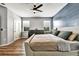 Spacious main bedroom with a stylish accent wall, modern ceiling fan, and plenty of natural light at 310 S Willow Ave # A, Tampa, FL 33606