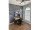 Stylish home office with floating shelves, a modern desk, and a ceiling fan at 310 S Willow Ave # A, Tampa, FL 33606