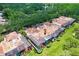 Stunning aerial view of homes with private pools enclosed by screened lanais and beautiful landscaping at 3145 Lake Ellen Dr # 3145, Tampa, FL 33618