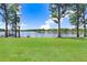 Scenic view of a lush lawn leading to a serene lake with a dock and gazebo at 3145 Lake Ellen Dr # 3145, Tampa, FL 33618