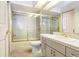 Tiled bathroom featuring a shower with a glass door, vanity with cabinets, and a sink at 3145 Lake Ellen Dr # 3145, Tampa, FL 33618