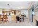 An open dining room features a long dining table set, a fireplace, and sliding glass door to the patio at 3145 Lake Ellen Dr # 3145, Tampa, FL 33618