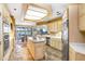 Bright kitchen with a central island, stainless steel appliances, and open floor plan to the dining area at 3145 Lake Ellen Dr # 3145, Tampa, FL 33618