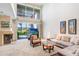 Bright living room with high ceilings, natural light, fireplace and view of the outdoor swimming pool at 3145 Lake Ellen Dr # 3145, Tampa, FL 33618