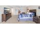 Well-lit main bedroom featuring neutral carpet, modern furnishings, and a television at 3145 Lake Ellen Dr # 3145, Tampa, FL 33618