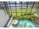 Aerial view of pool, including a jacuzzi and lush landscaping by the lake at 3145 Lake Ellen Dr # 3145, Tampa, FL 33618