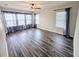 Spacious bedroom with plank flooring, large windows, and tasteful curtains creating a bright ambiance at 32599 Natural Bridge Rd, Wesley Chapel, FL 33543