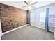 Bedroom with a ceiling fan, wood accent wall, plush carpet and natural light at 32599 Natural Bridge Rd, Wesley Chapel, FL 33543